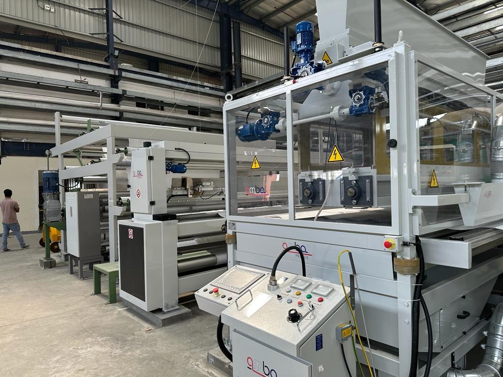 Modern textile machine with control panel on the factory floor